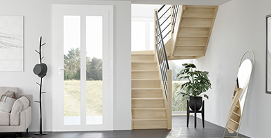 Image showing a bright, modern interior with a tailor-made wooden staircase leading to an upper floor.